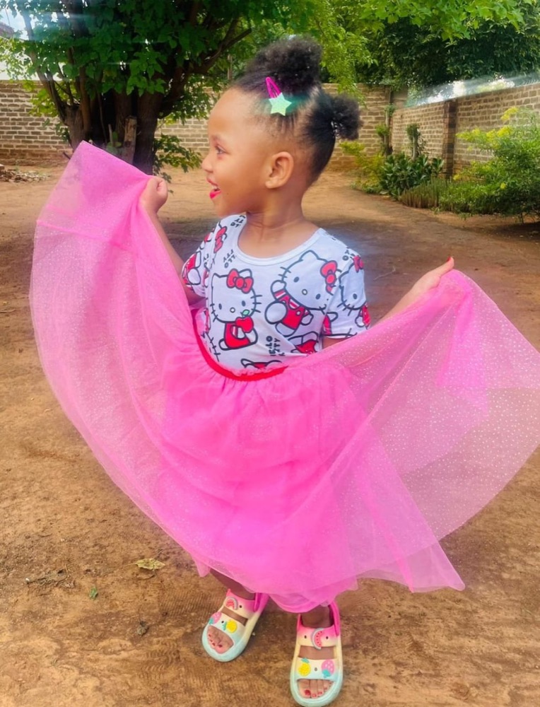 A child wearing a neat natural hairstyle