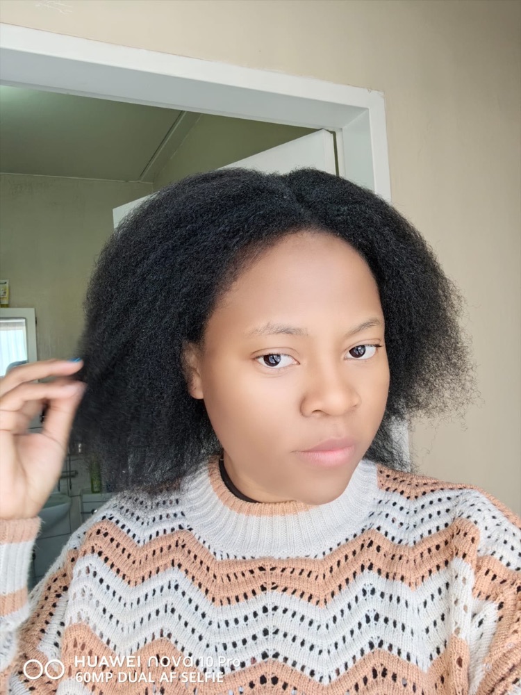 A customer showing her full natural hair