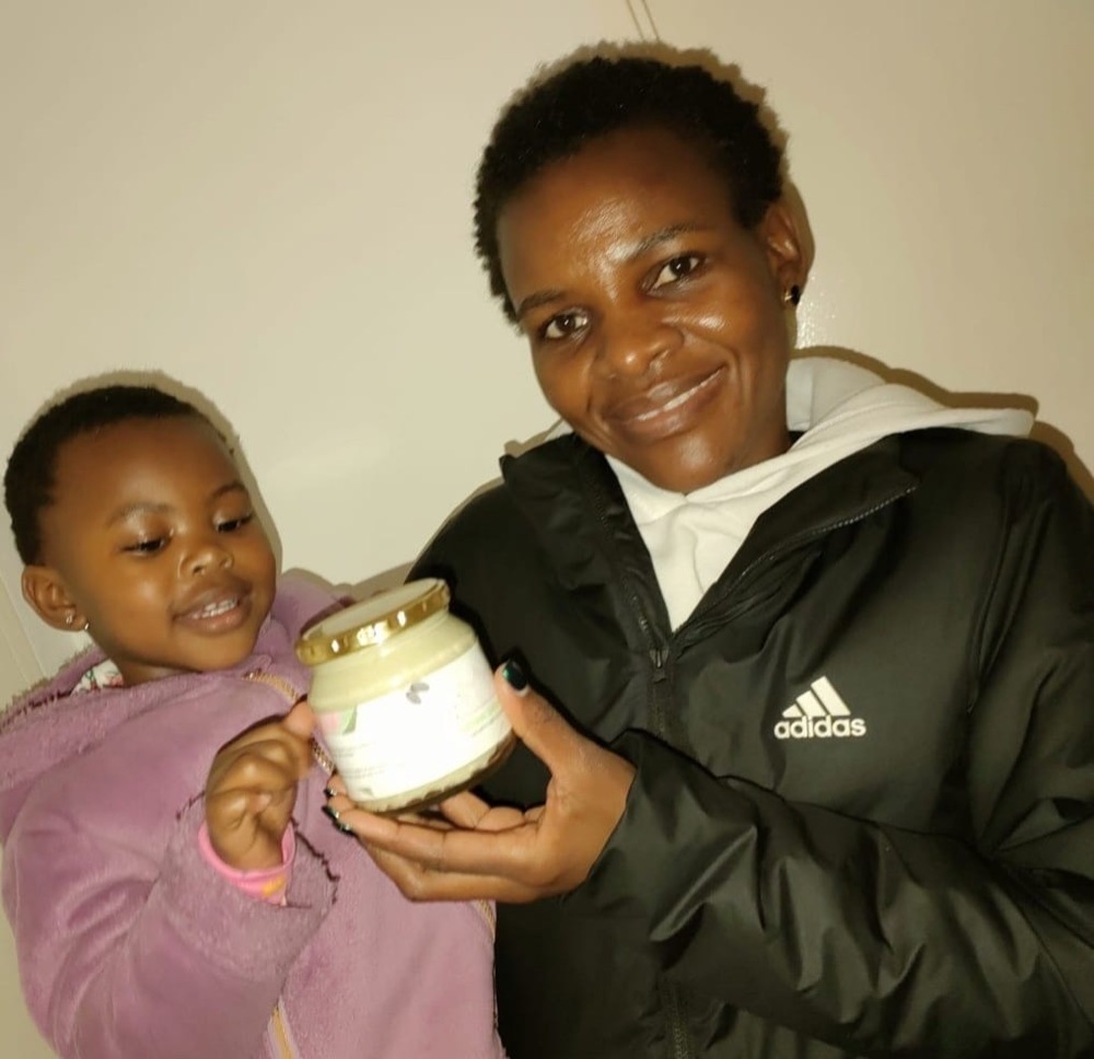 A parent and child holding their Sienna Shea Butter
